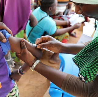 Measles vaccination campaign in Burkina Faso. At a refugee site in the North-Central region, a child is vaccinated against measles