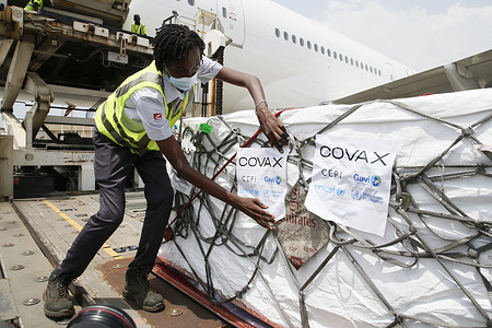 Workers offload boxes of AstraZeneca/Oxford vaccines as the country receives its first batch of coronavirus disease (COVID-19) vaccines under COVAX scheme, in Abidjan, Ivory Coast February 26, 2021. 504 thousand doses of the Astrazeneca / Oxford vaccine were received in Abidjan. Vaccination against COVID-19 begins March 1 in Côte d'Ivoire